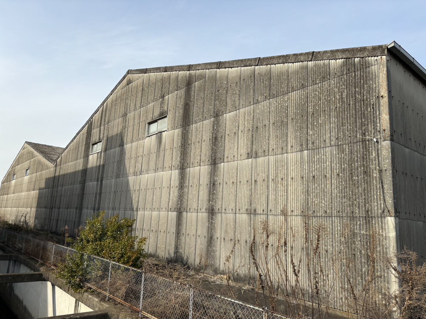 川越町の大型倉庫のスレート壁劣化具合