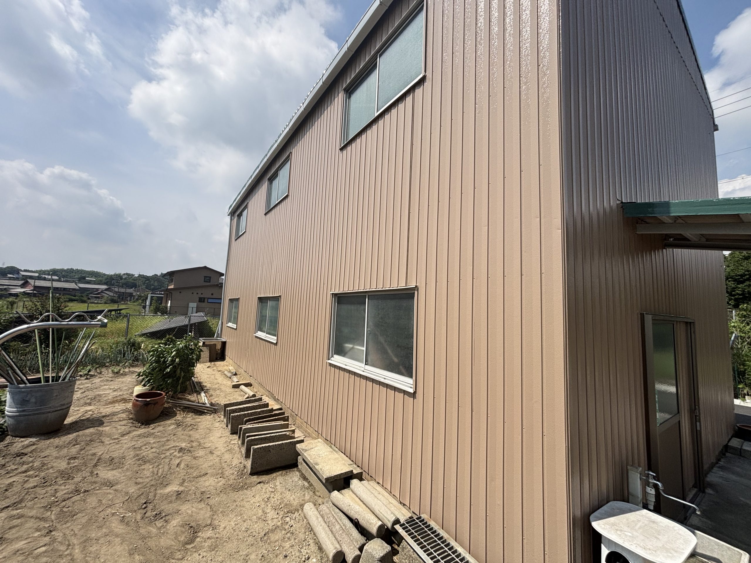 施工前にサビが広がっていた農機具倉庫の角波板金外壁と、塗装後に美しく蘇った外壁の比較写真